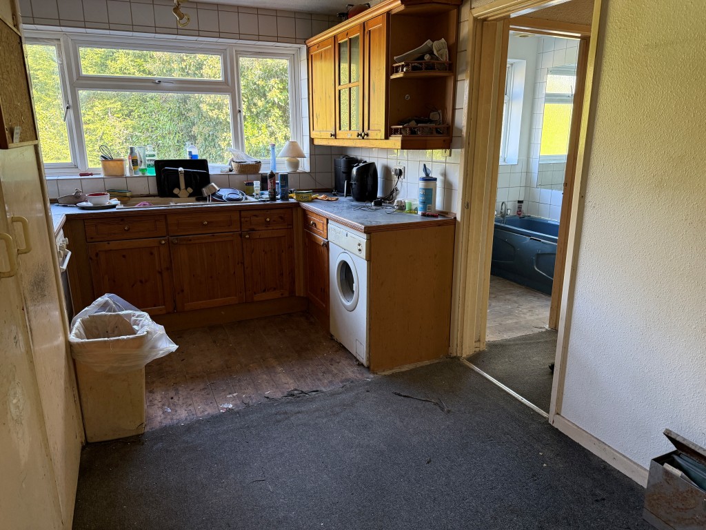 Lot: 134 - TWO-BEDROOM FLAT WITH GARAGE IN NEED OF UPDATING - Kitchen with dining area and fitted units